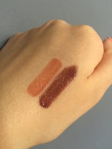 Lip gloss swatches in natural light. Melon on top and Vixen on bottom.