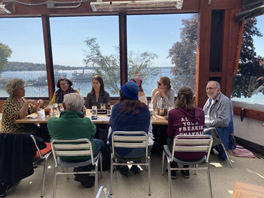 People sitting at a table with a view of Lake Geneva