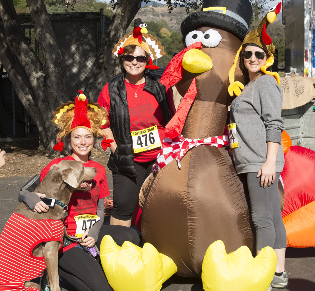 Racers embrace a giant turkey at a Tofurky Trot